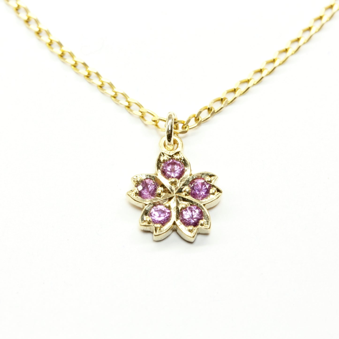 Gold & pink sapphire cherry blossom pendant in gold